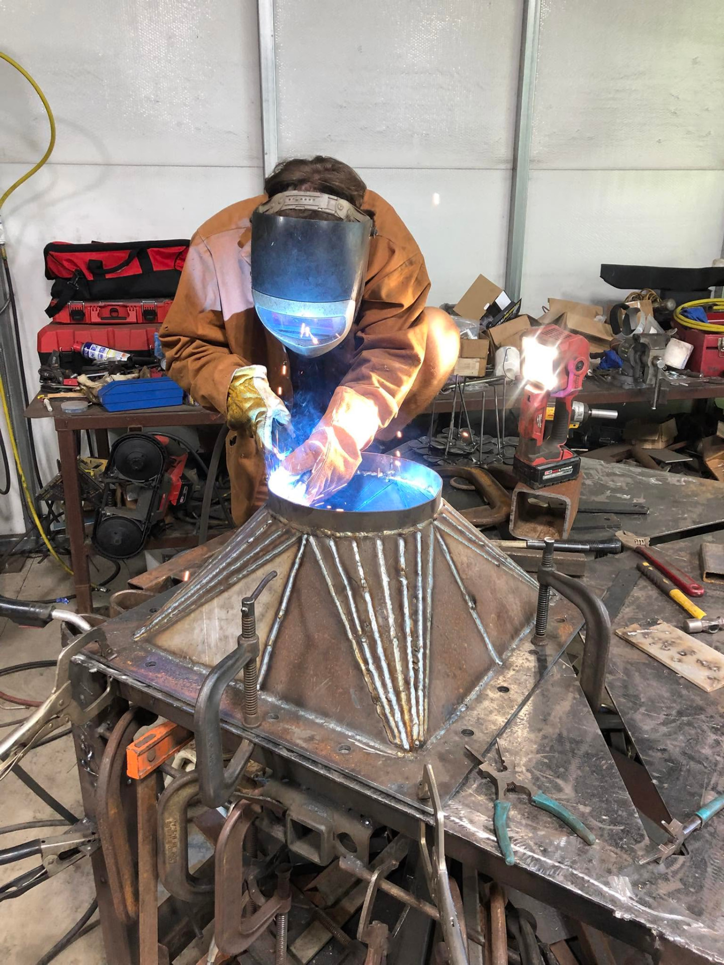 Welder joining a custom steel assembly in the James Fabrication shop